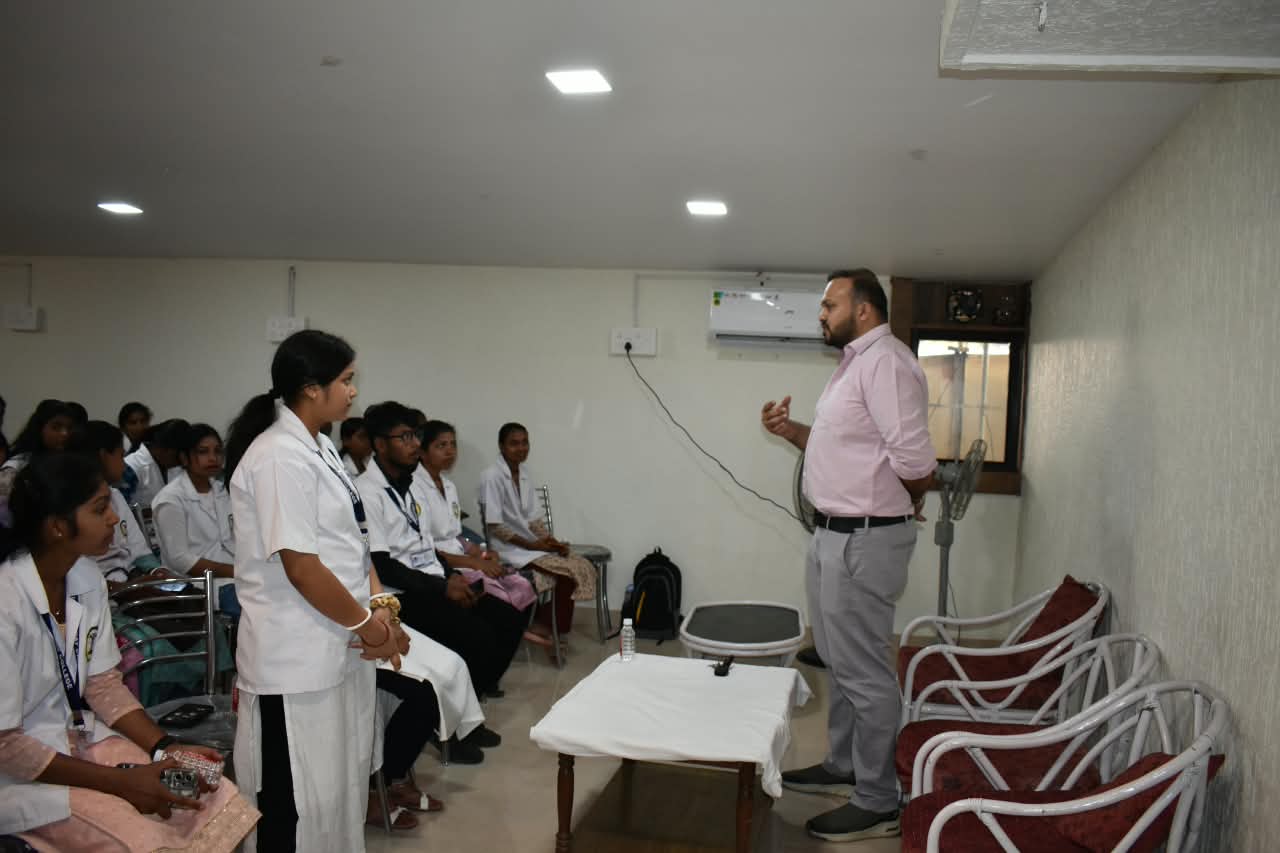 Dr. Ekansh Debuka speaking with nursing students in a classroom session