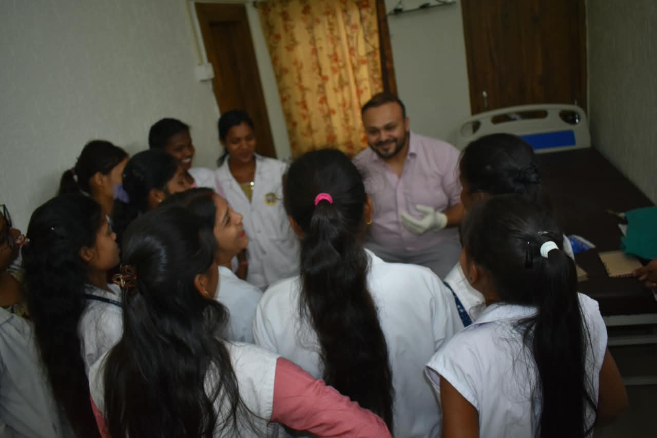 Nursing students gathered around Dr. Ekansh Debuka during practical teaching