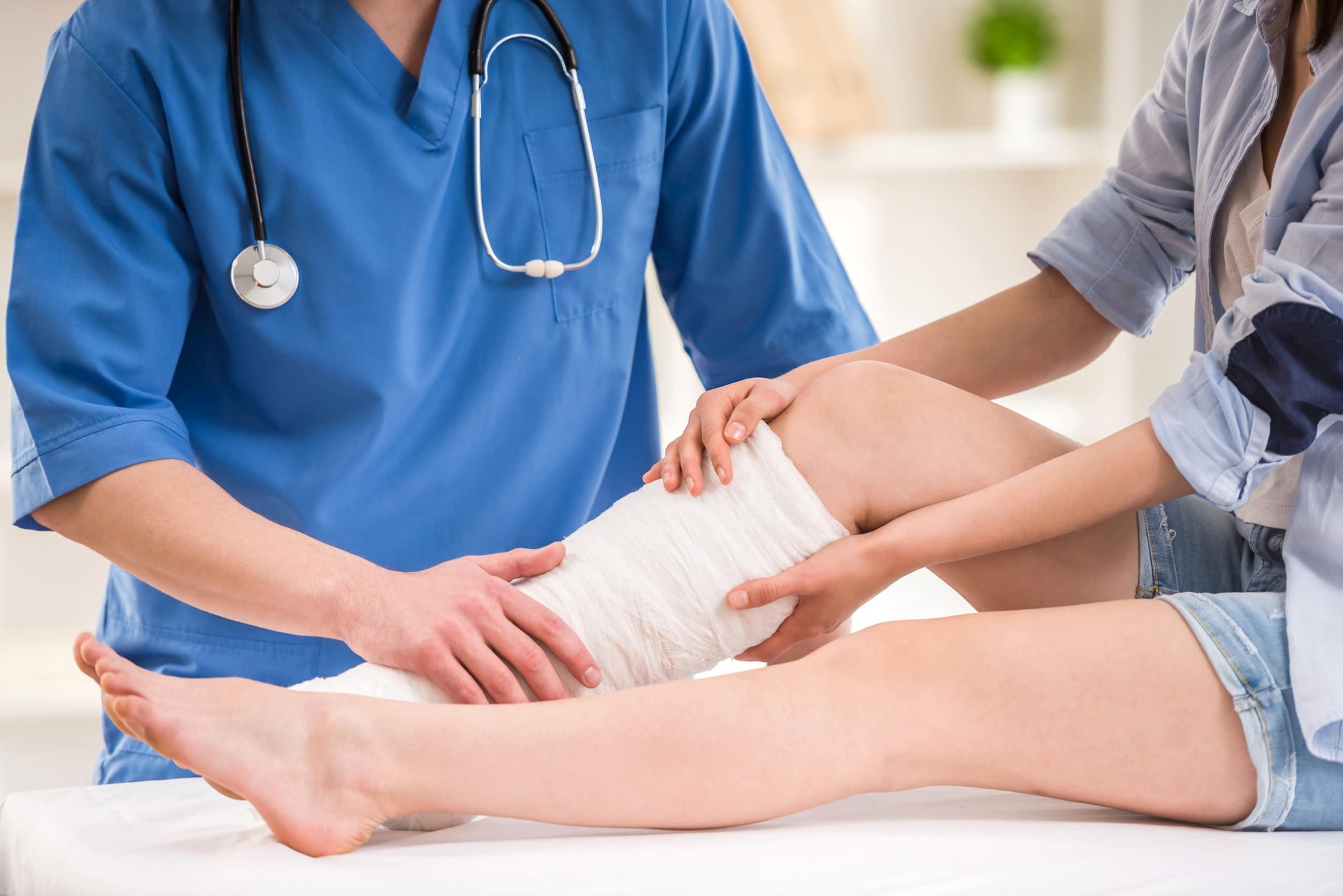 Doctor assessing a patient's bandaged leg