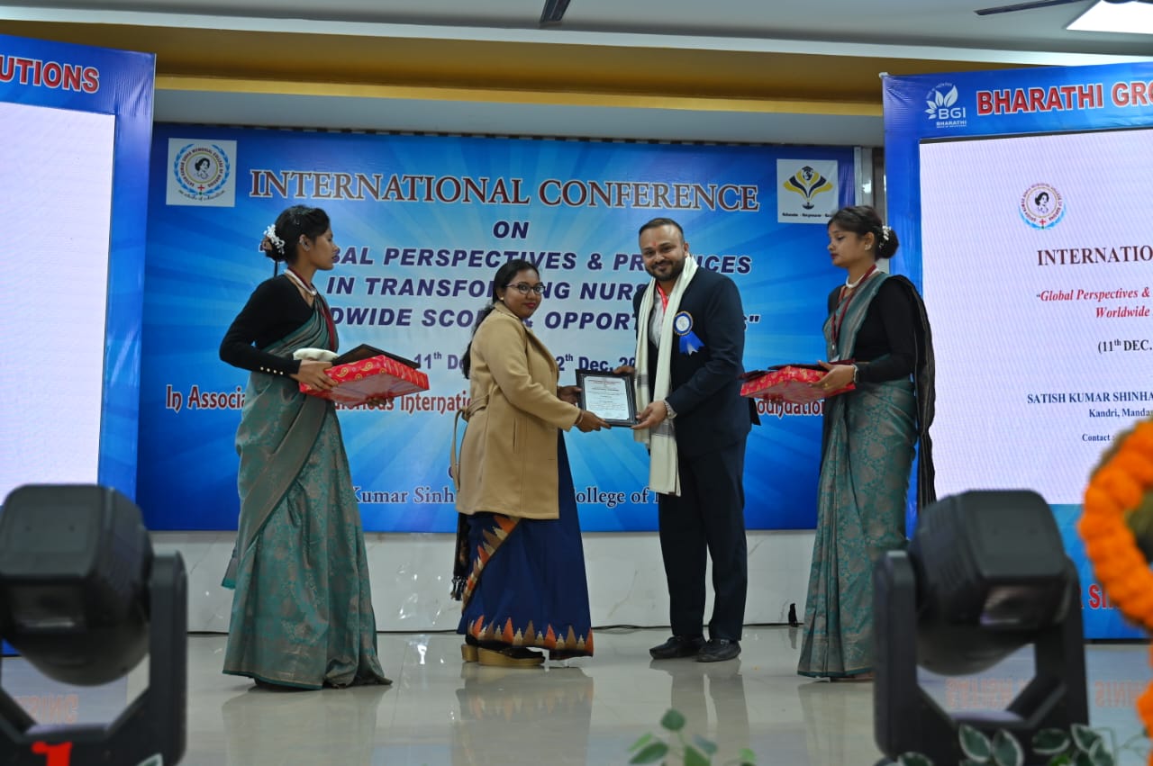 Dr. Ekansh Debuka receiving recognition at an international nursing conference