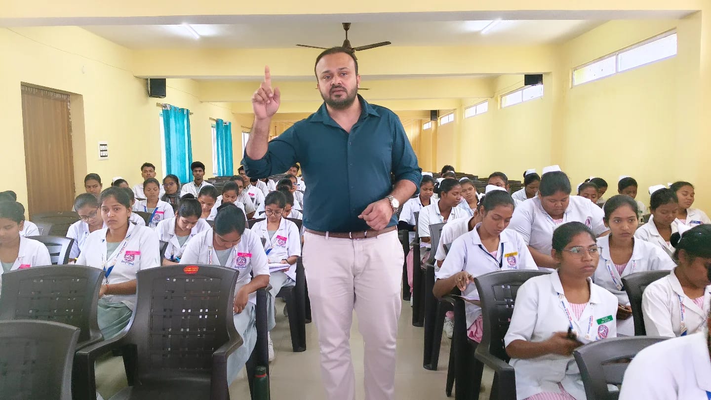 Dr. Ekansh Debuka guiding nursing students during a classroom activity